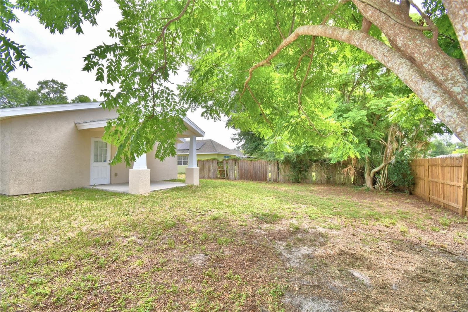 Left corner of backyard looking to the house - 2456 BATES AVE SW, WINTER HAVEN
