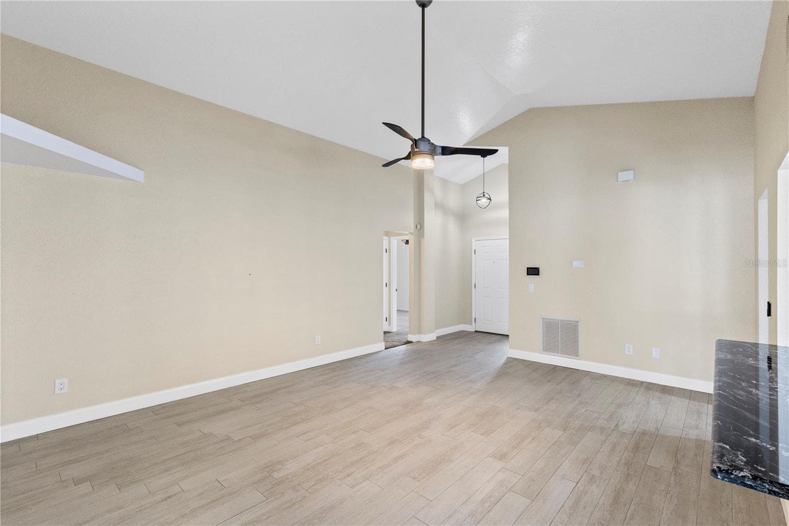 Living room off Front entry overlooking kitchen and dining area - 10057 SANDBAR ST, ORLANDO