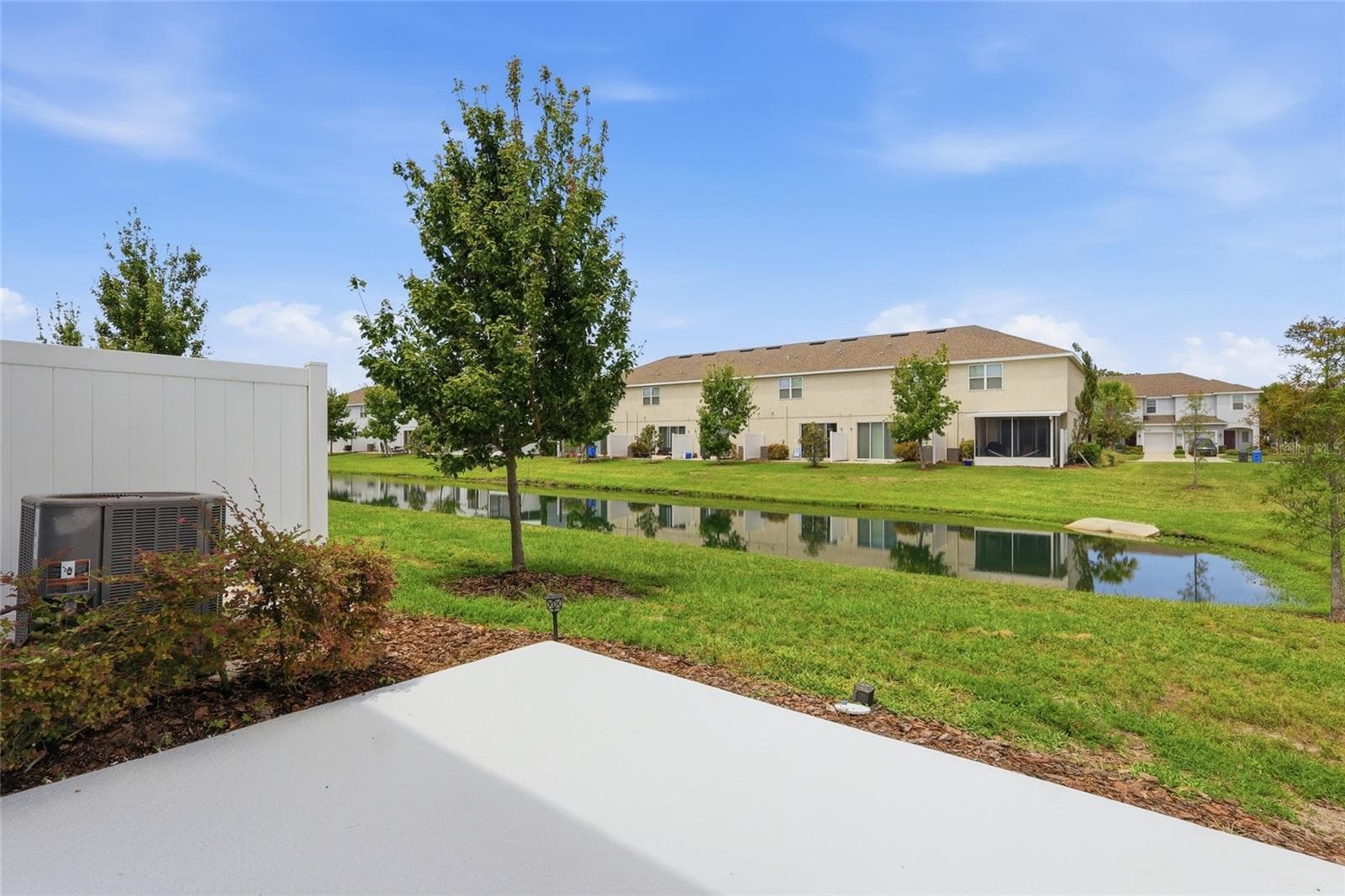 Additional rear exterior view highlighting the home's location along the water - 7005 GRAND ELM DR, RIVERVIEW