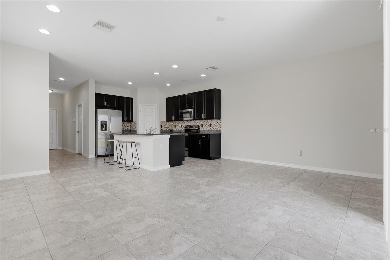Kitchen view highlighting the oversized island with bar seating - 7005 GRAND ELM DR, RIVERVIEW