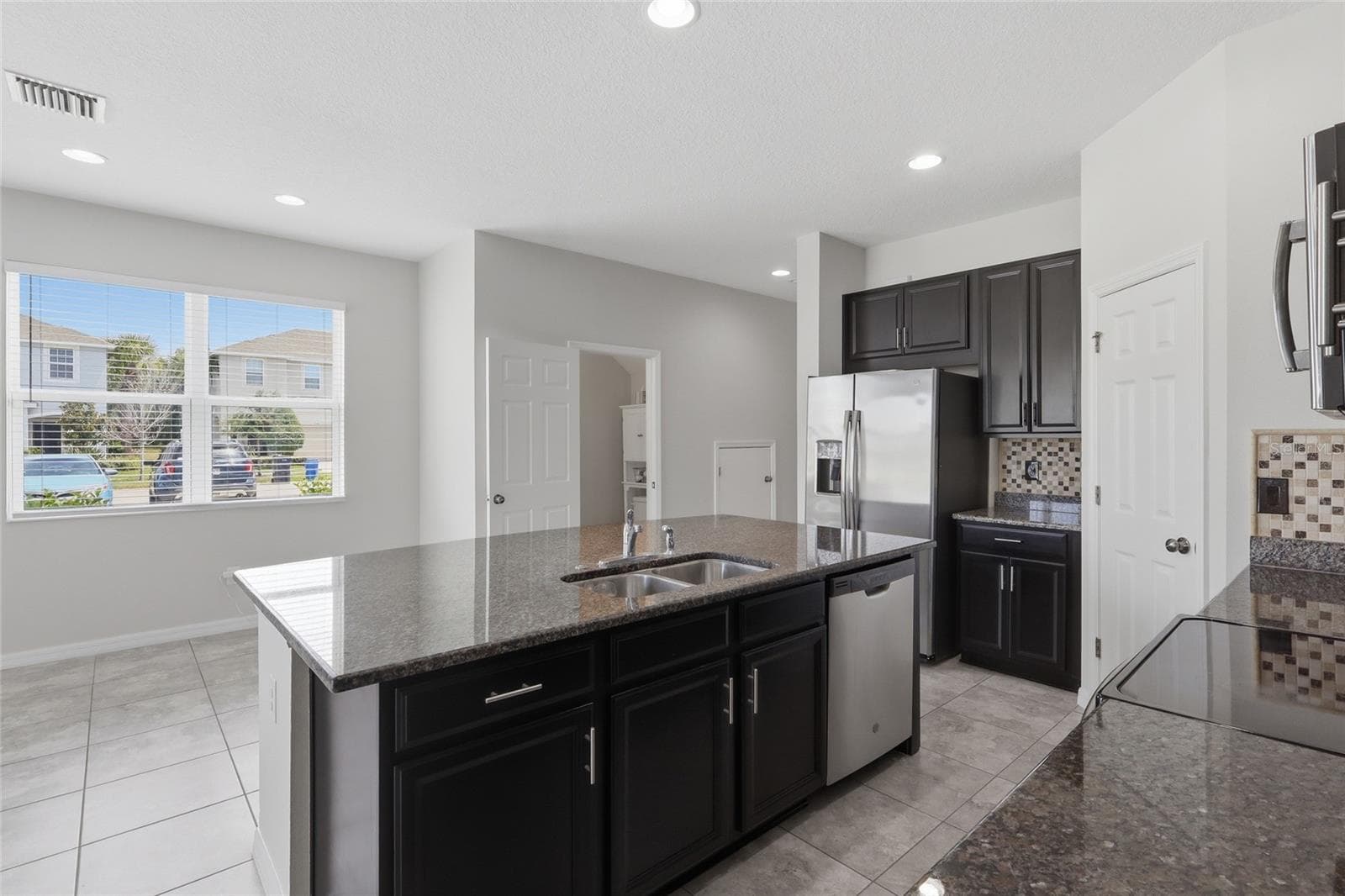 Kitchen overlooking the open living and dining areas - 7005 GRAND ELM DR, RIVERVIEW