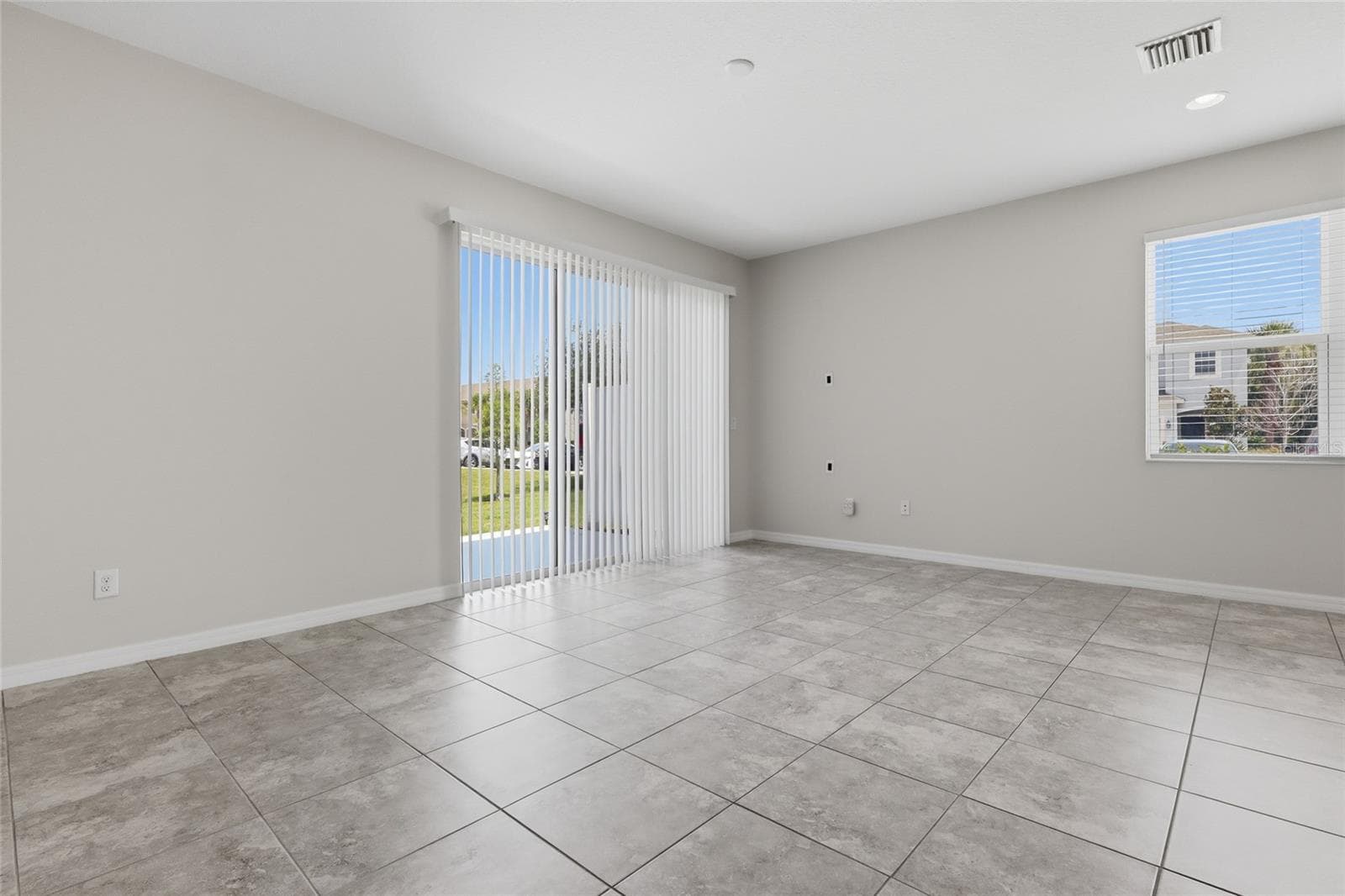 Spacious living room with tile flooring and an open flow to the kitchen - 7005 GRAND ELM DR, RIVERVIEW