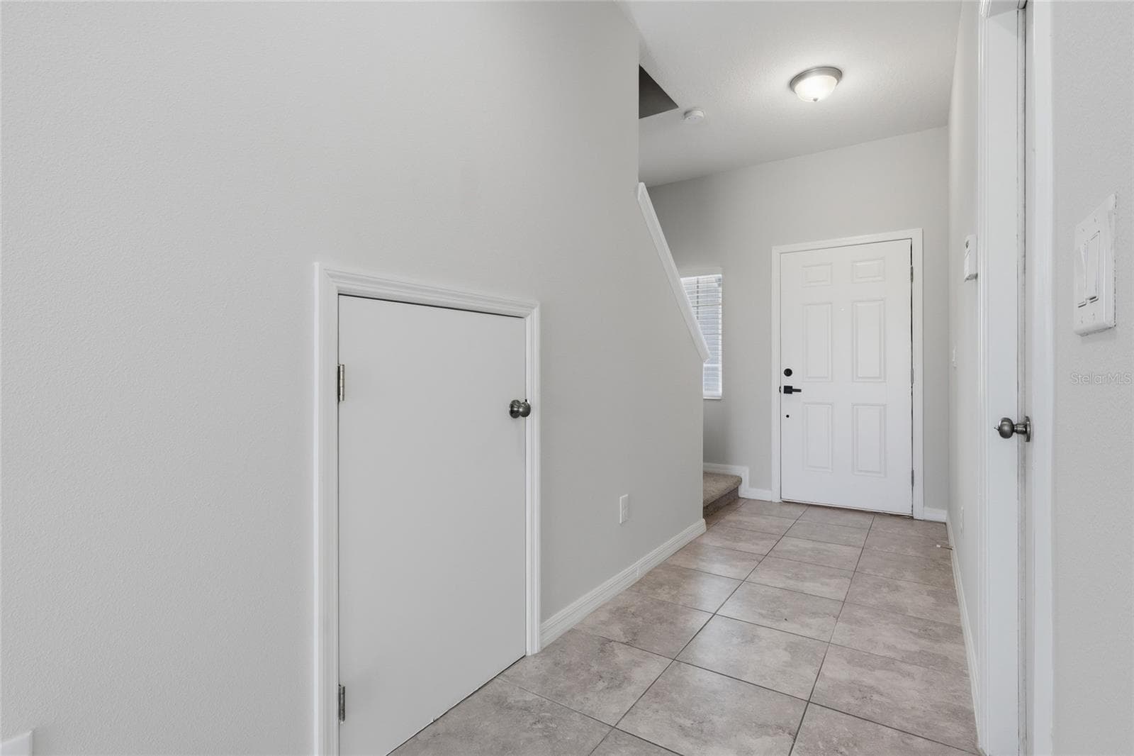 Open foyer with tile flooring and access to the stairs and main living area - 7005 GRAND ELM DR, RIVERVIEW
