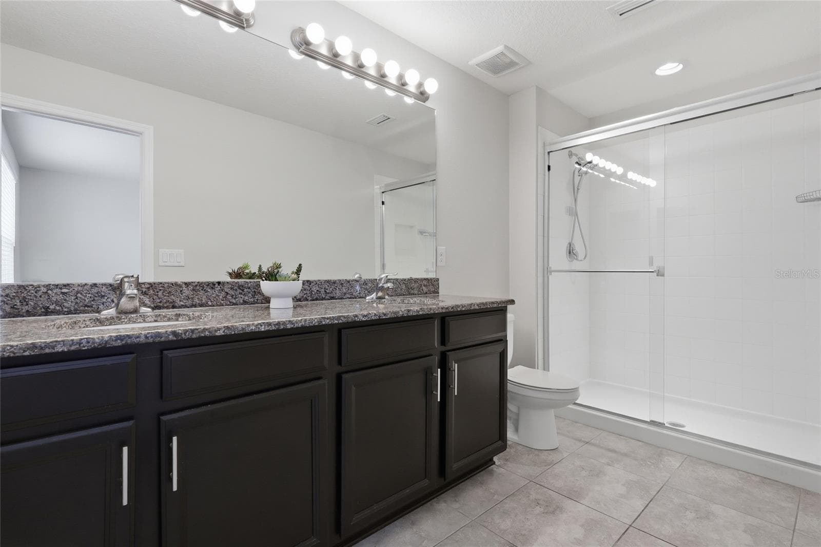 Primary bathroom featuring dual vanity and a step in shower - 7005 GRAND ELM DR, RIVERVIEW