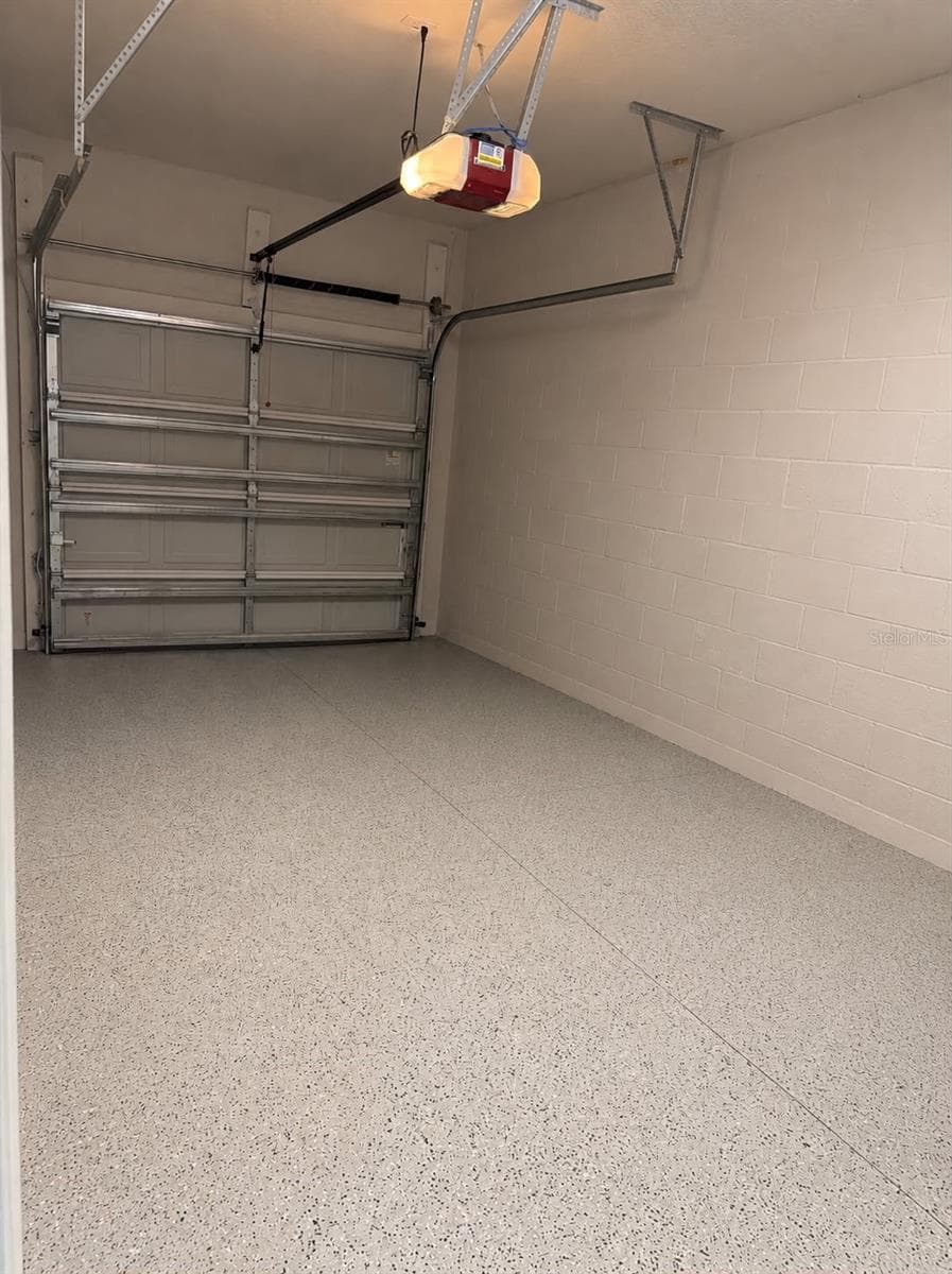 Car garage with epoxy flooring, offering ample storage and parking space - 7005 GRAND ELM DR, RIVERVIEW