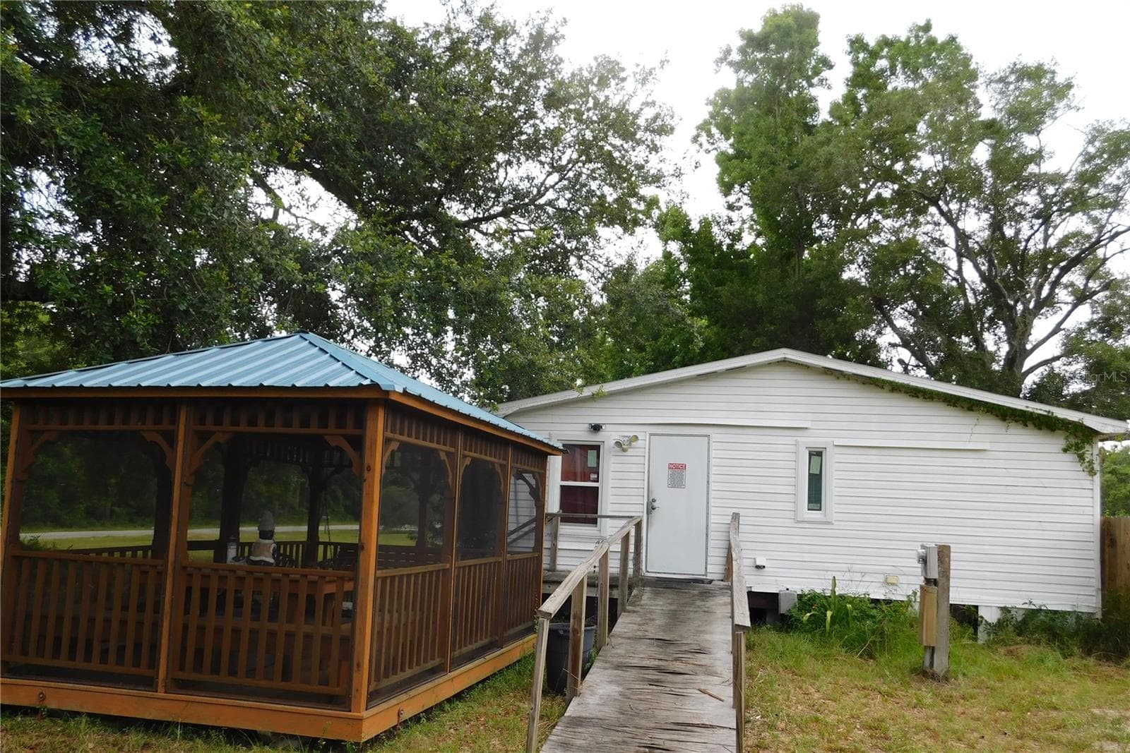Side of home and side of Gazebo at main home - 30501 CLEARVIEW DR, WESLEY CHAPEL