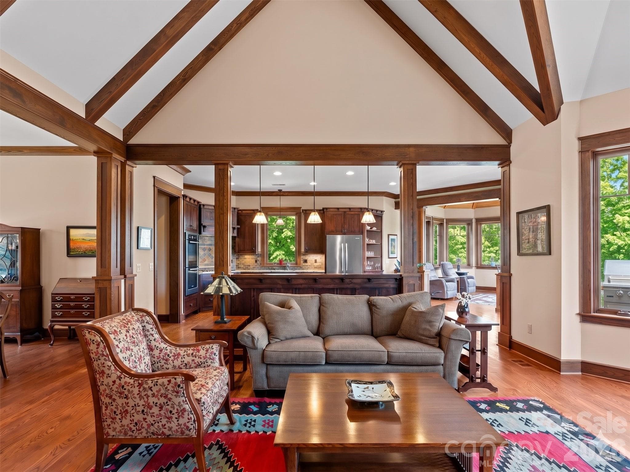 Large family room with stone wood burning fireplace, Oak hardwoods, custom wood trim, vaulted ceilings and large windows with mountain views. - Hendersonville