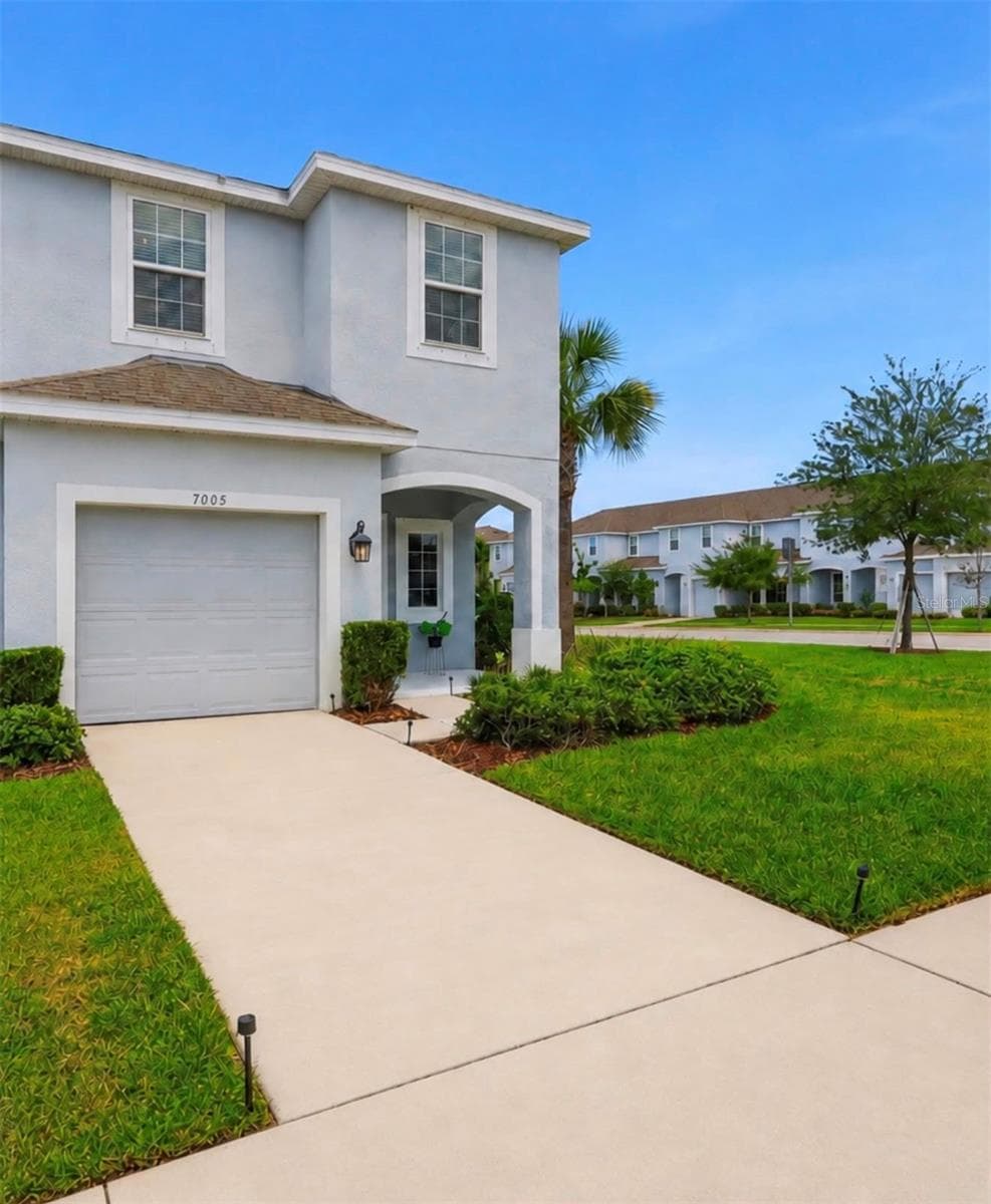Additional front view highlighting the covered entry and car garage - 7005 GRAND ELM DR, RIVERVIEW