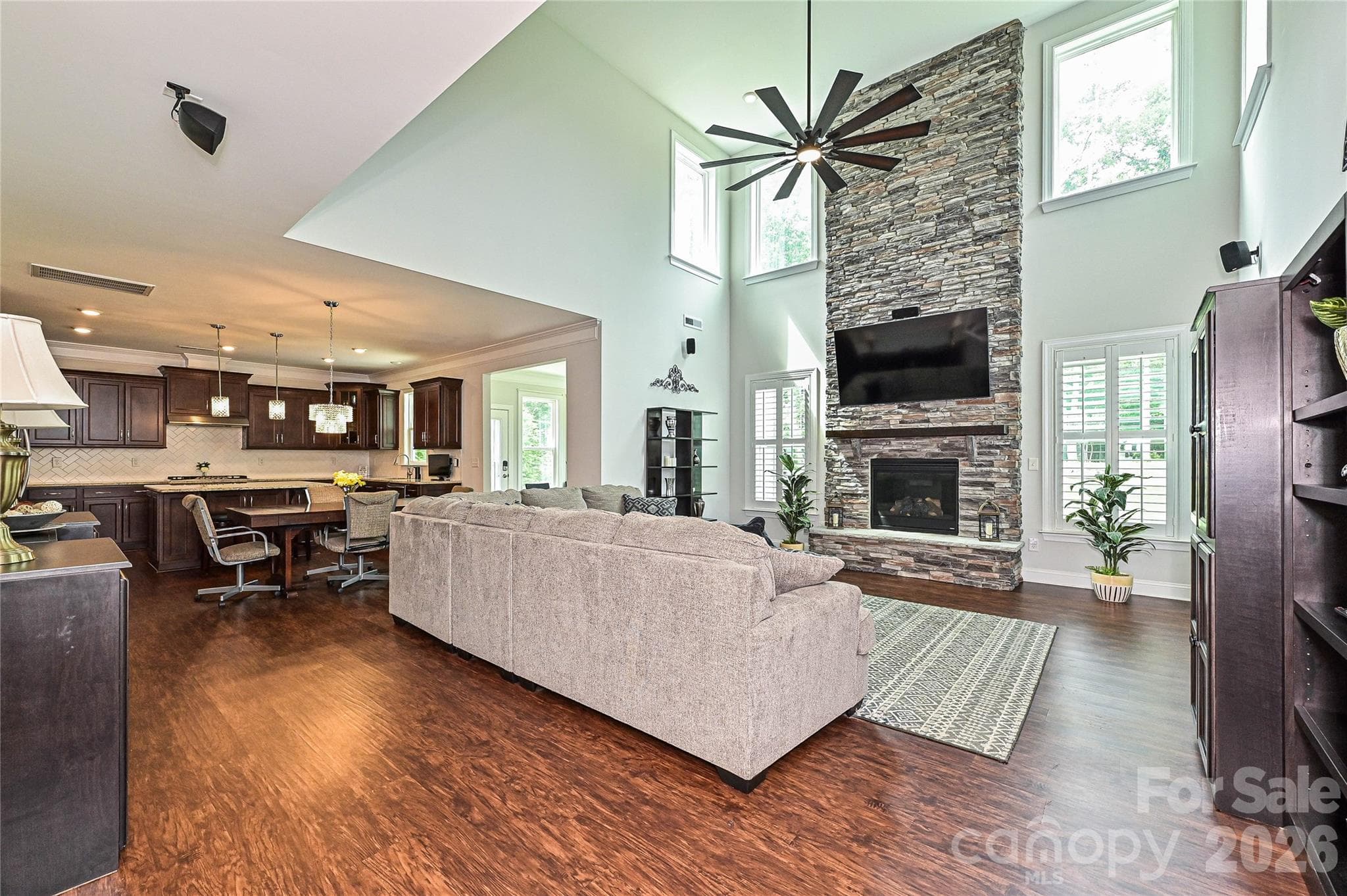 Beautiful two-story great room has an abundance of natural light and a gorgeous stone fireplace! - Waxhaw