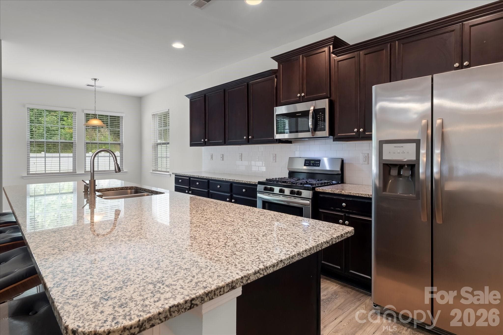 Gourmet kitchen with large island, granite countertops, stainless steel appliances (refrigerator stays for new owner) - Mooresville