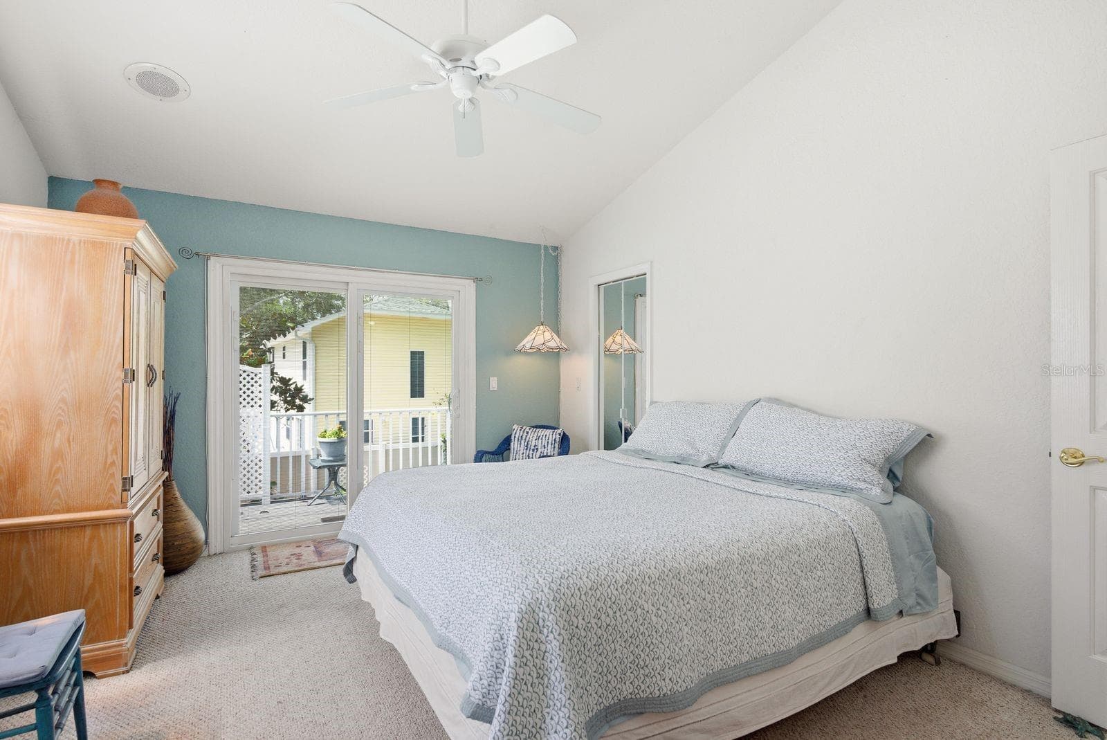 Upstairs Primary bedroom. Hurricane rated sliders with built in blinds lead to balcony. - 755 SAN CHRISTOPHER DR, DUNEDIN