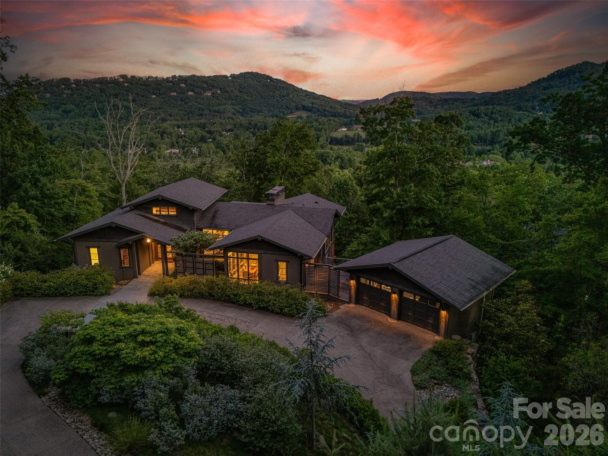 Twilight view showcasing the home's dramatic setting and architectural presence - Arden