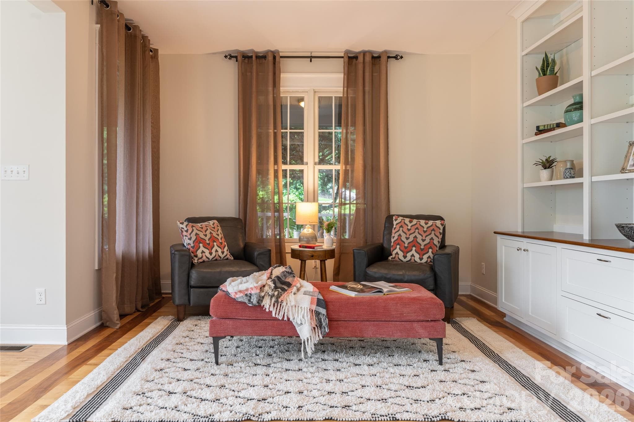 The formal sitting area features custom built-ins that provide an inviting space to welcome guests. - 33 Bridle Path Drive, Barnardsville