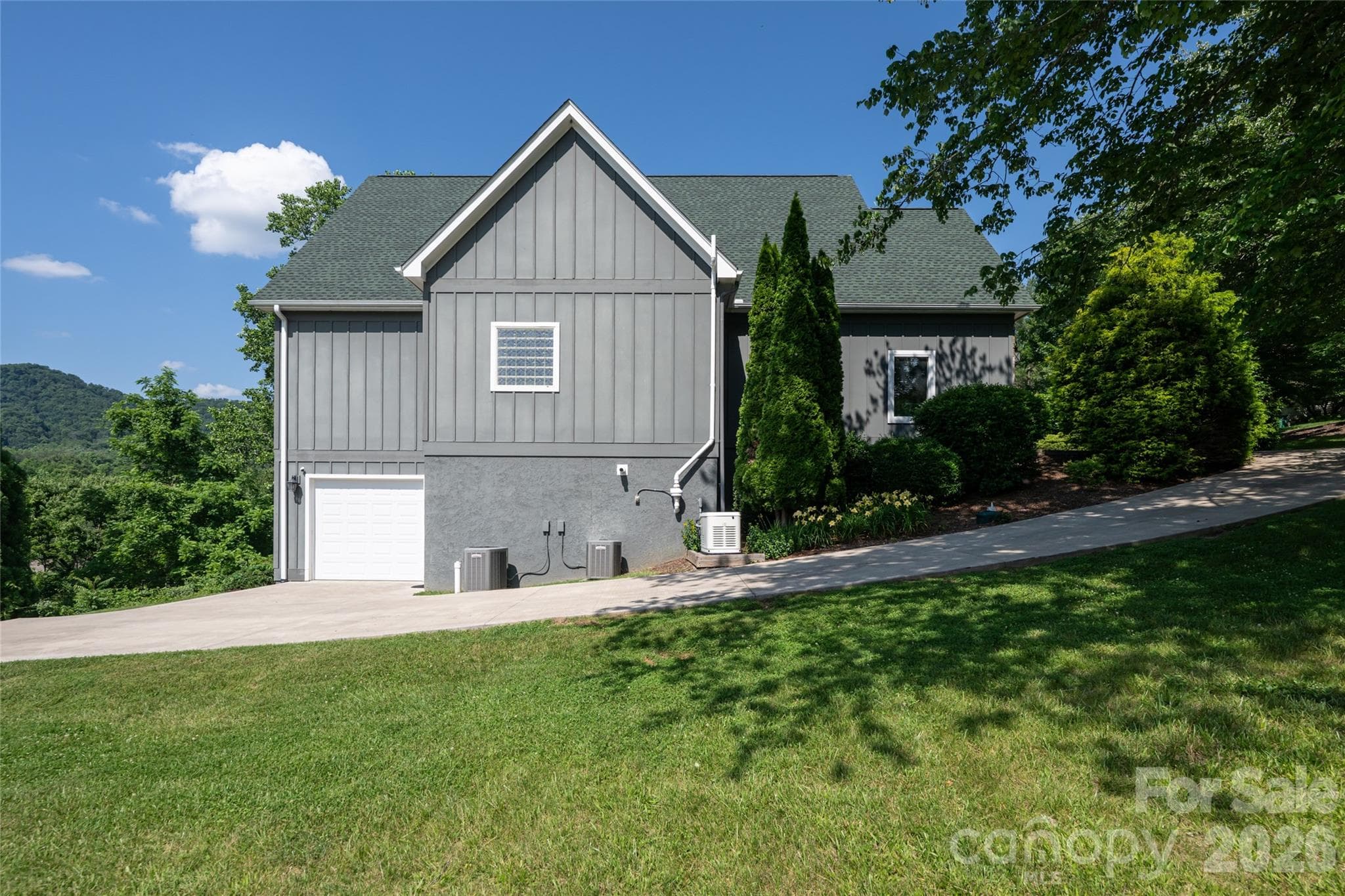 Generator, radon mitigation and dual heat pumps along the lower level driveway leading to the 3rd car garage. - 33 Bridle Path Drive, Barnardsville