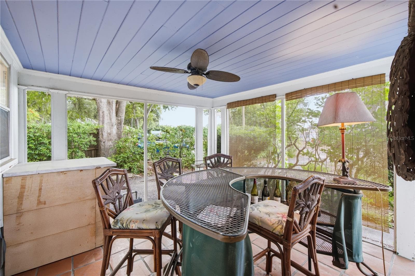 Screened lanai with built-in tiki bar — perfect for relaxing or entertaining. - 411 W 48TH ST, BRADENTON