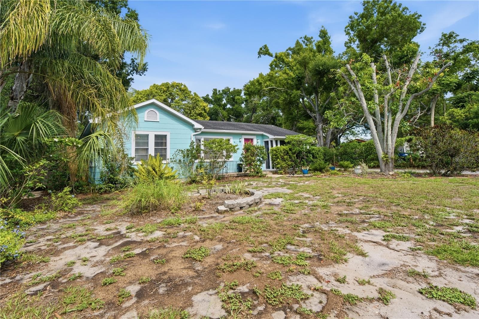 Large private deck with pergola and tropical landscaping for outdoor living. - 411 W 48TH ST, BRADENTON