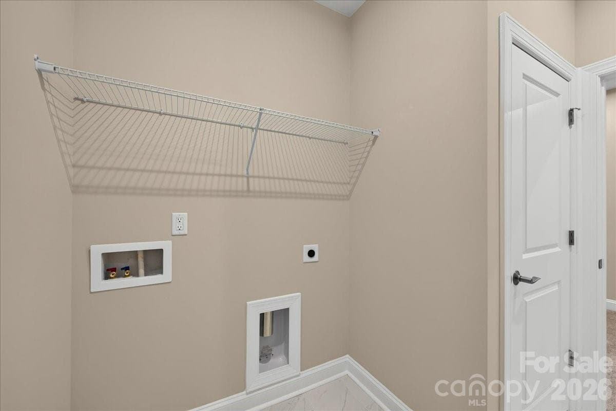 Laundry room with access to the primary closet - 232 Old Town Village Road, Waxhaw