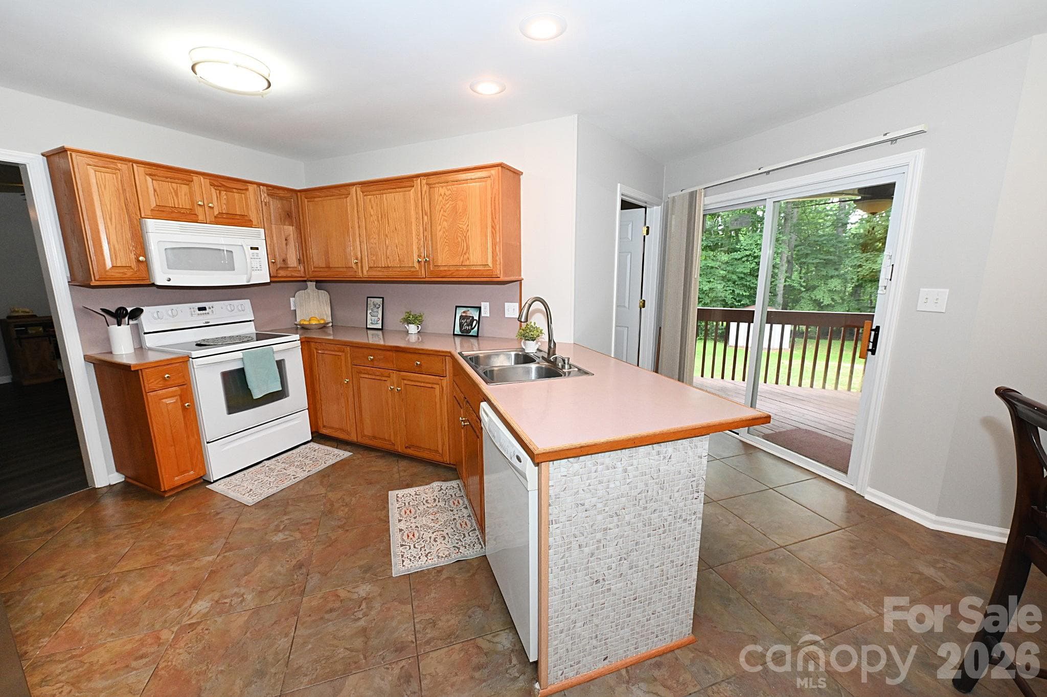 Kitchen with patio door leading to covered rear porch - Newton