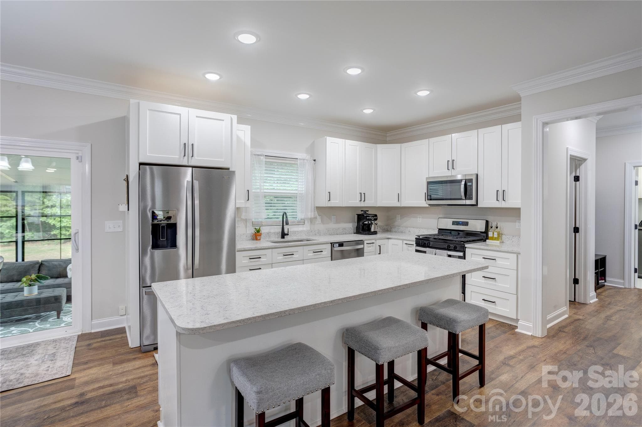 Pristine, chef-inspired kitchen with oversized island, stainless steel appliances and plenty of cabinets for storage. - 317 Oak Brook Drive, Salisbury