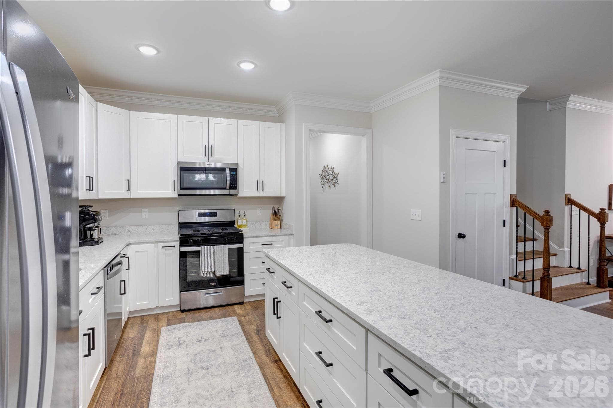 Notice the wide drawers in the island, trash pull out cabinet beside the refrigerator and HUGE storage closet beside stairs that turns for MORE storage under stairs. - 317 Oak Brook Drive, Salisbury