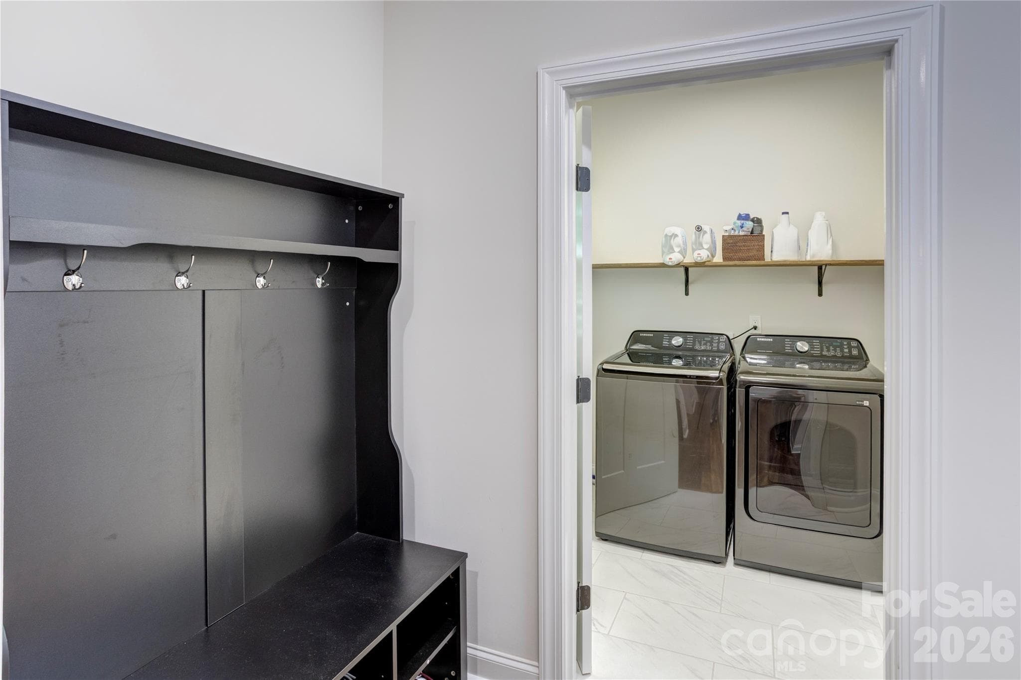 The drop zone greets you inside the garage hallway leading to the large laundry room and downstairs half bath. - 317 Oak Brook Drive, Salisbury