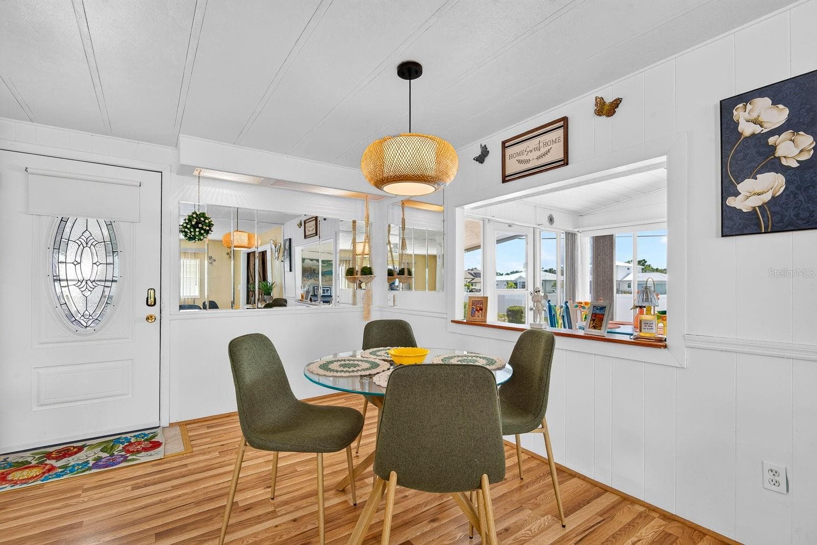 Entry into home showing dining area off to the side and open front lanai - 2107 PALMA SOLA BLVD #17, BRADENTON