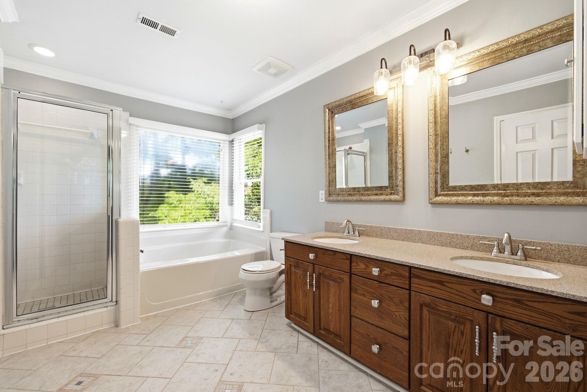 Primary bathroom with separate shower and tub combo - beautiful cabinet and counters - Dual sinks - 503 Wyre Forest Court, Charlotte