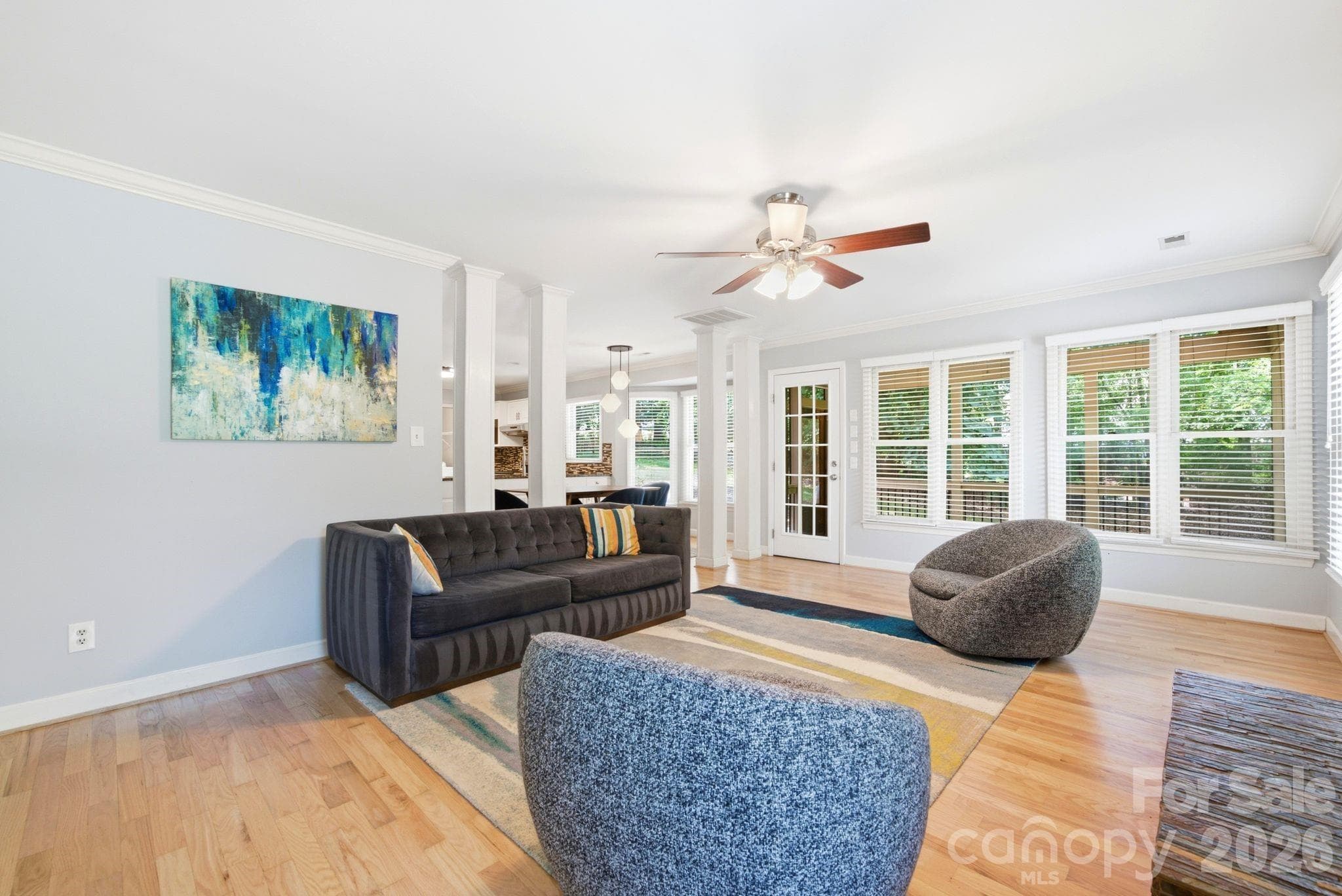 Living room area with views of backyard scenery and screened in porch - 503 Wyre Forest Court, Charlotte