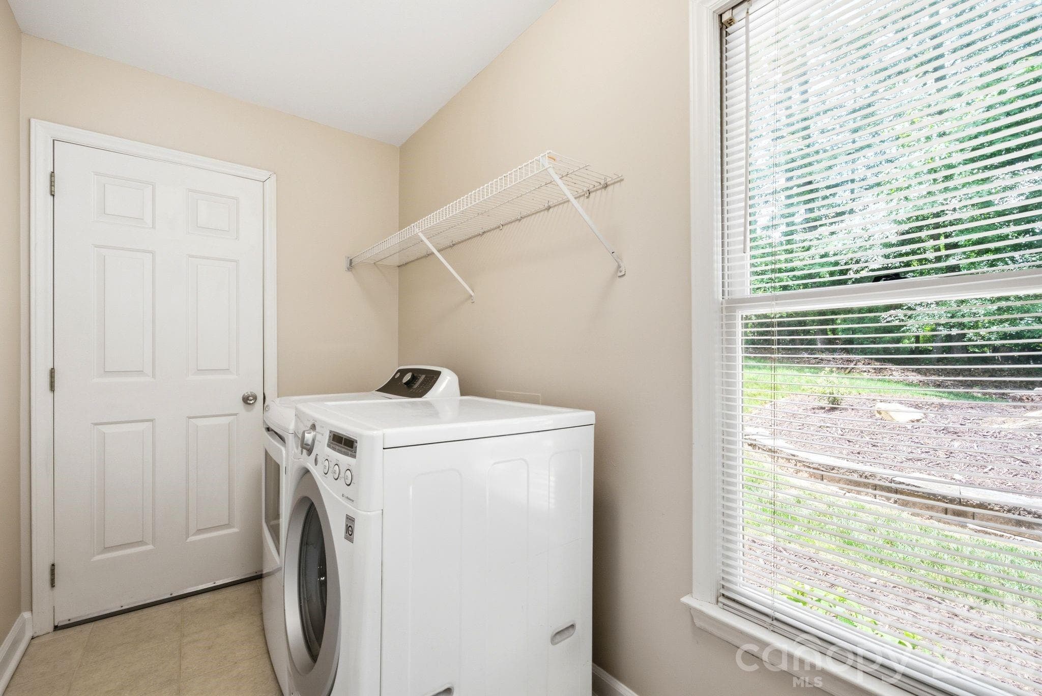 Laundry room and utility closet (water heater and storage space) with natural light - 503 Wyre Forest Court, Charlotte