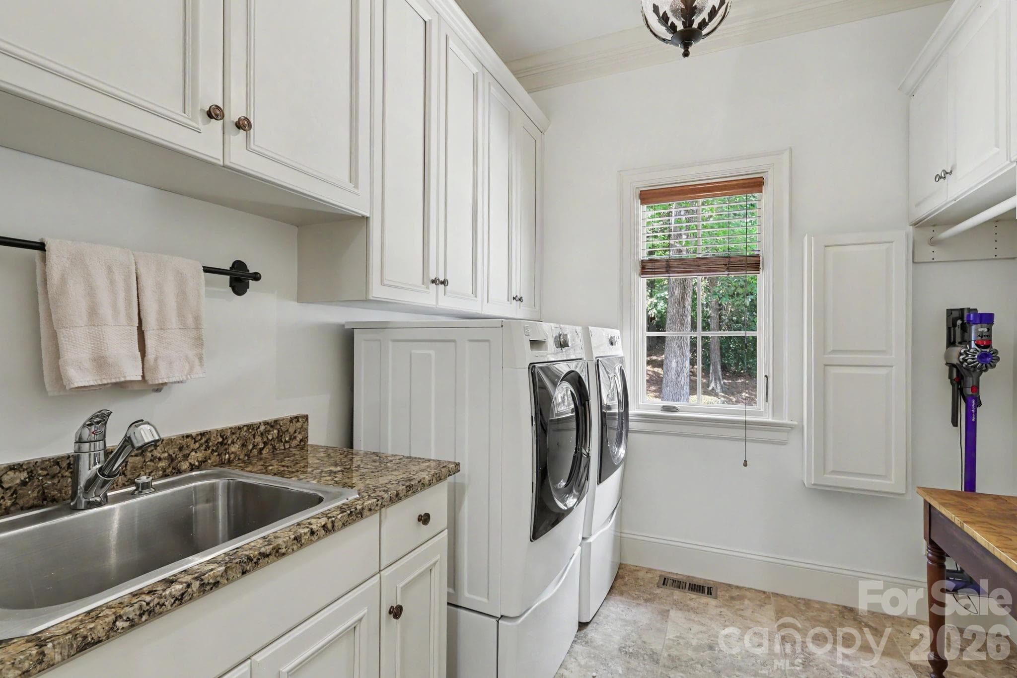 Generous Laundry with iron board, sink and cabinets! - Matthews