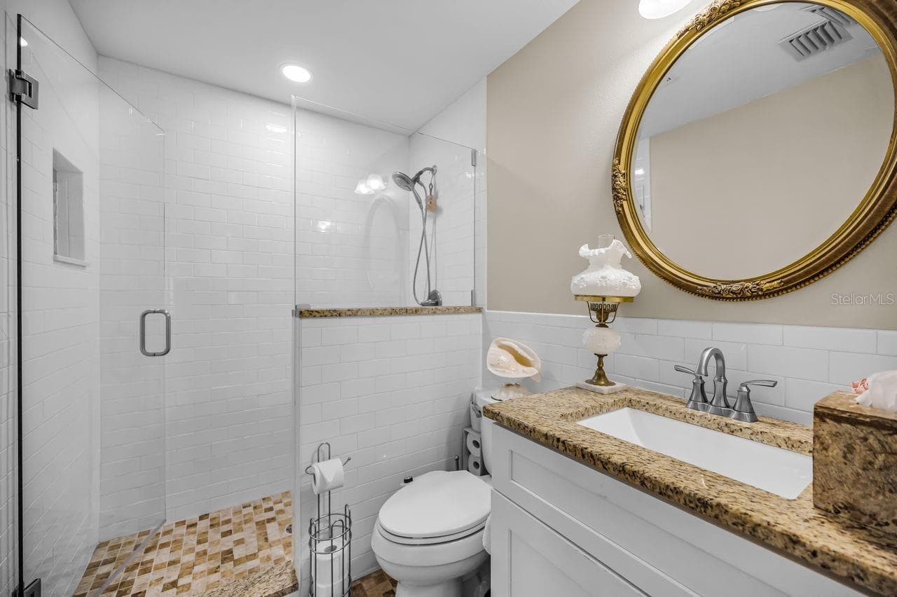 Walk-in shower, granite top and tiled flooring. - 732 NE OAK ST, ST PETERSBURG