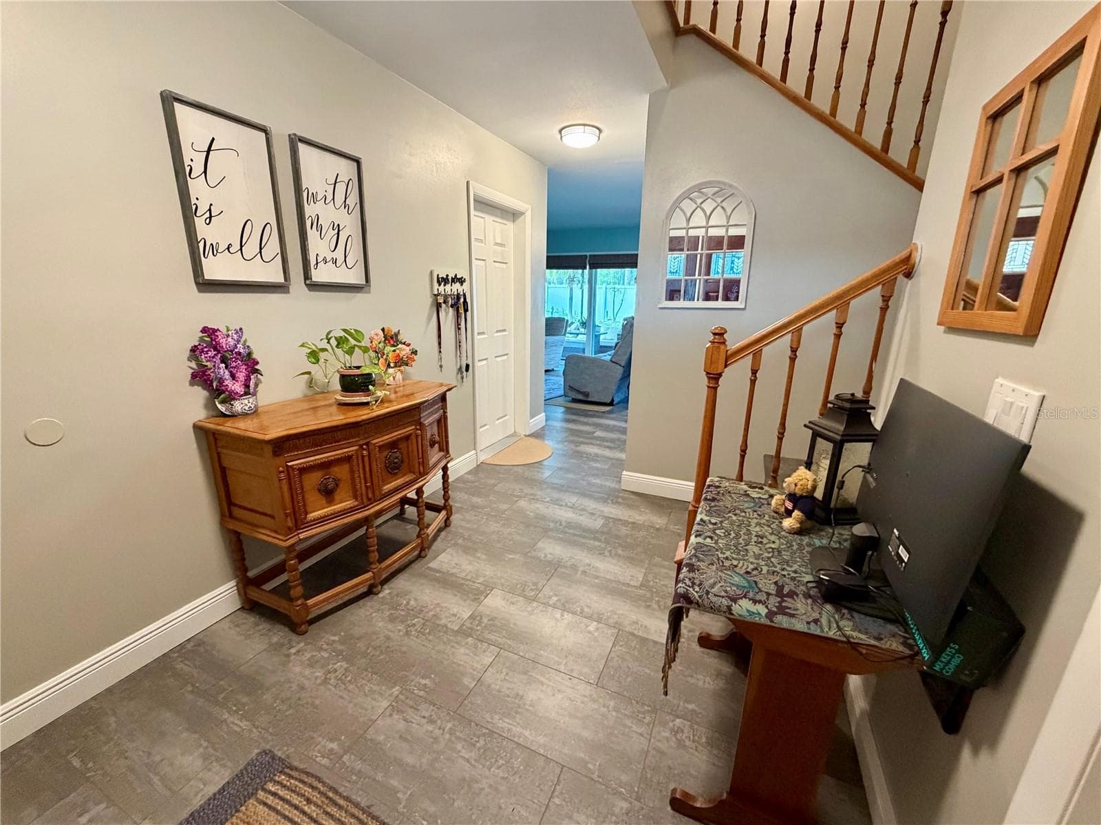 Stairs from the foyer lead to the living room, dining room and kitchen on main living level - 15705 CASHMERE LN, TAMPA