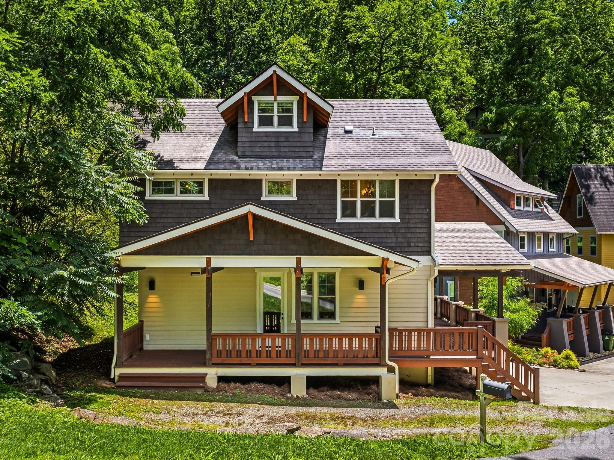 Charming curb appeal featuring a spacious covered wrap-around front porch. - Asheville