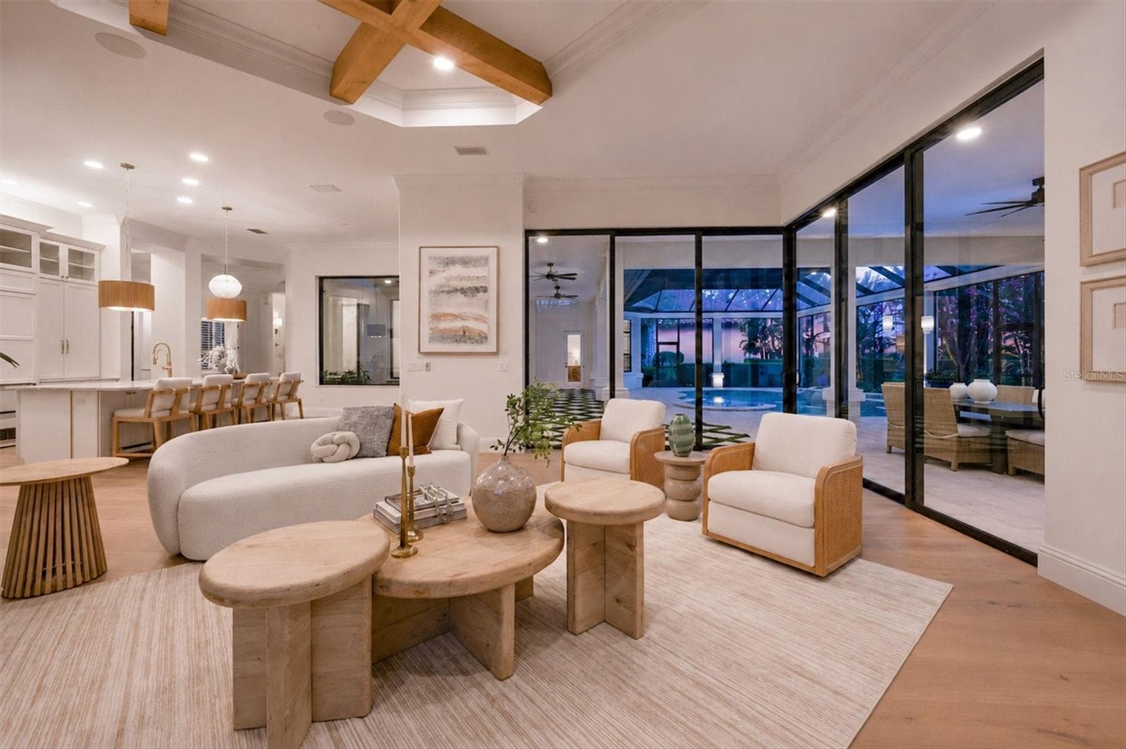 Family Room with Corner Sliders and Pool View at Twilight - 9261 MCDANIEL LN, SARASOTA