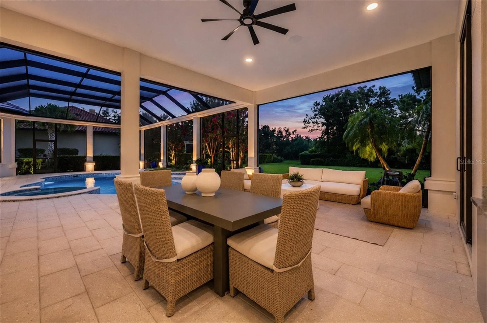 Lanai Dining Space at Twilight - 9261 MCDANIEL LN, SARASOTA