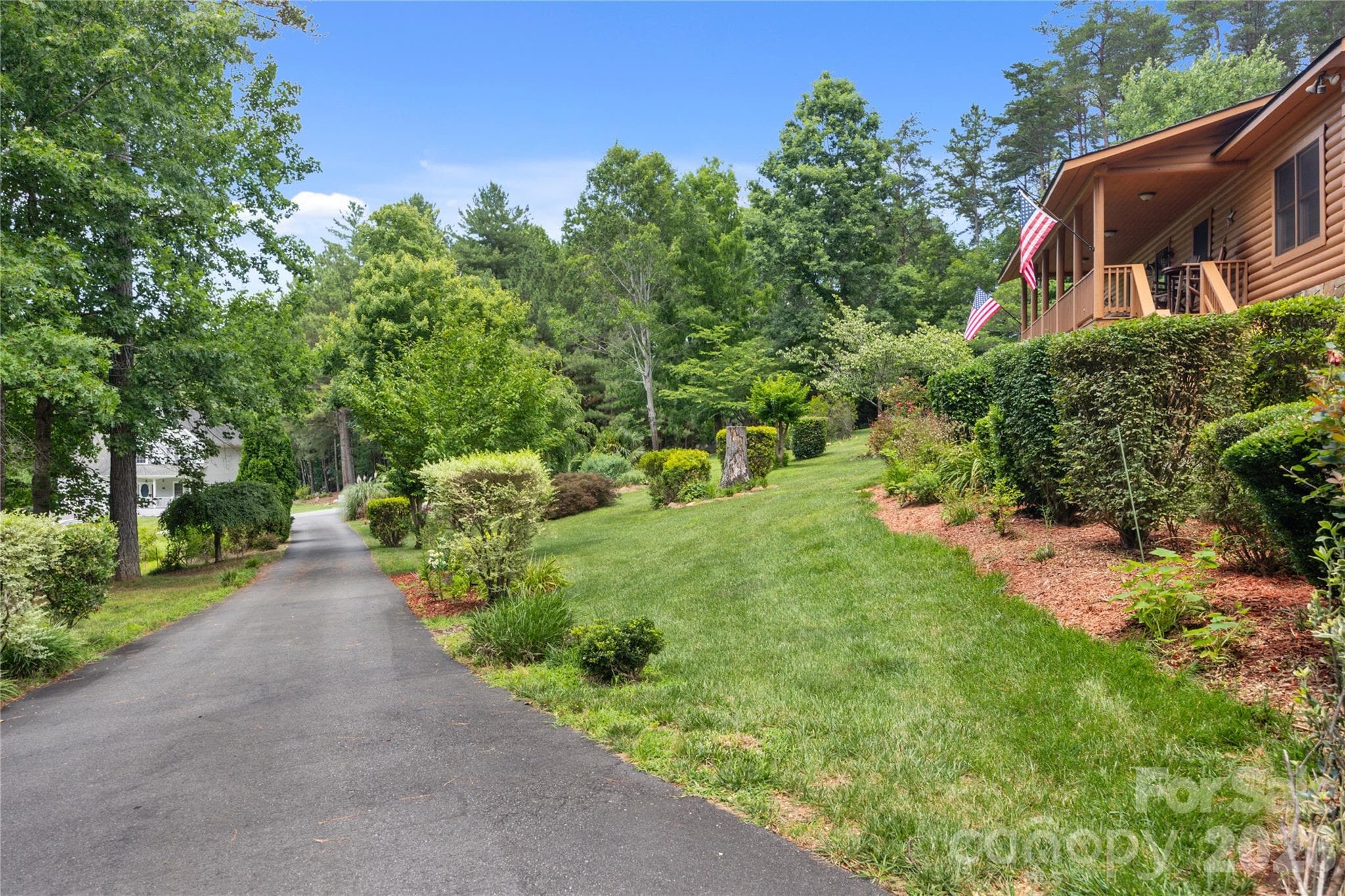 Recently paved driveway flows through the picture-perfect yard lovingly maintained and thoughtfully designed. - 214 Harbor Ridge Drive, Connelly Springs