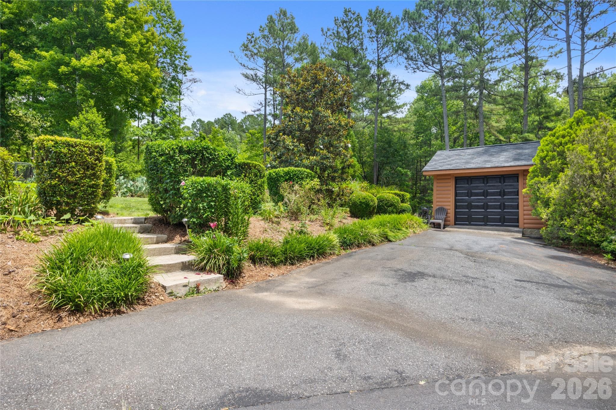 Beautifully cared-for property featuring a spacious golf cart garage. - 214 Harbor Ridge Drive, Connelly Springs