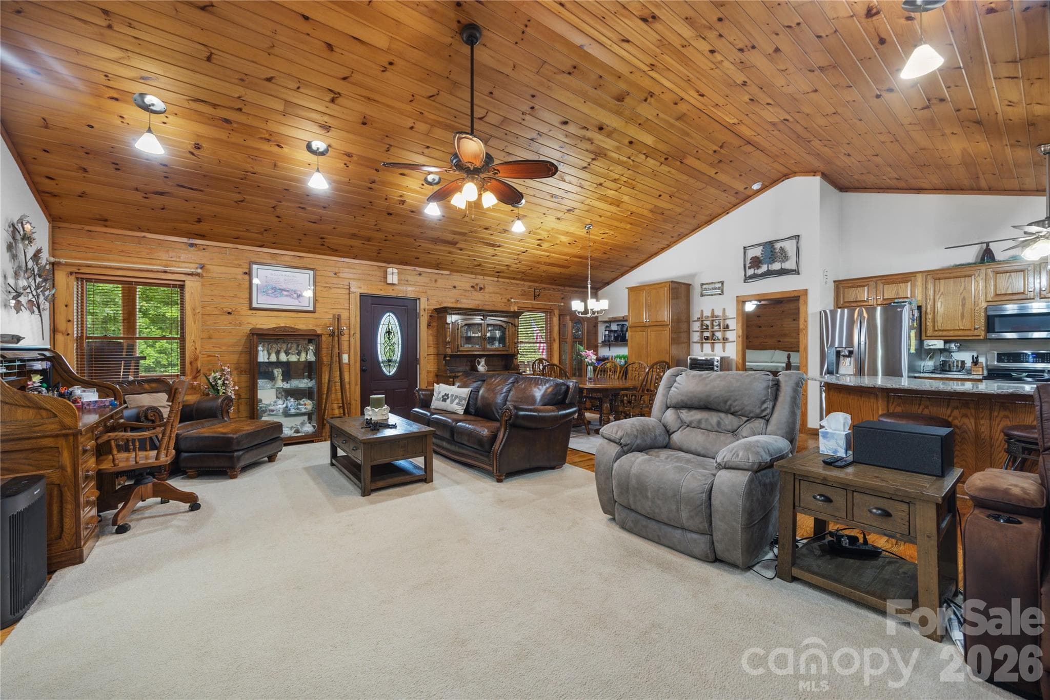 Beautiful oak walls and ceiling add warmth and rustic charm to this great room. - 214 Harbor Ridge Drive, Connelly Springs