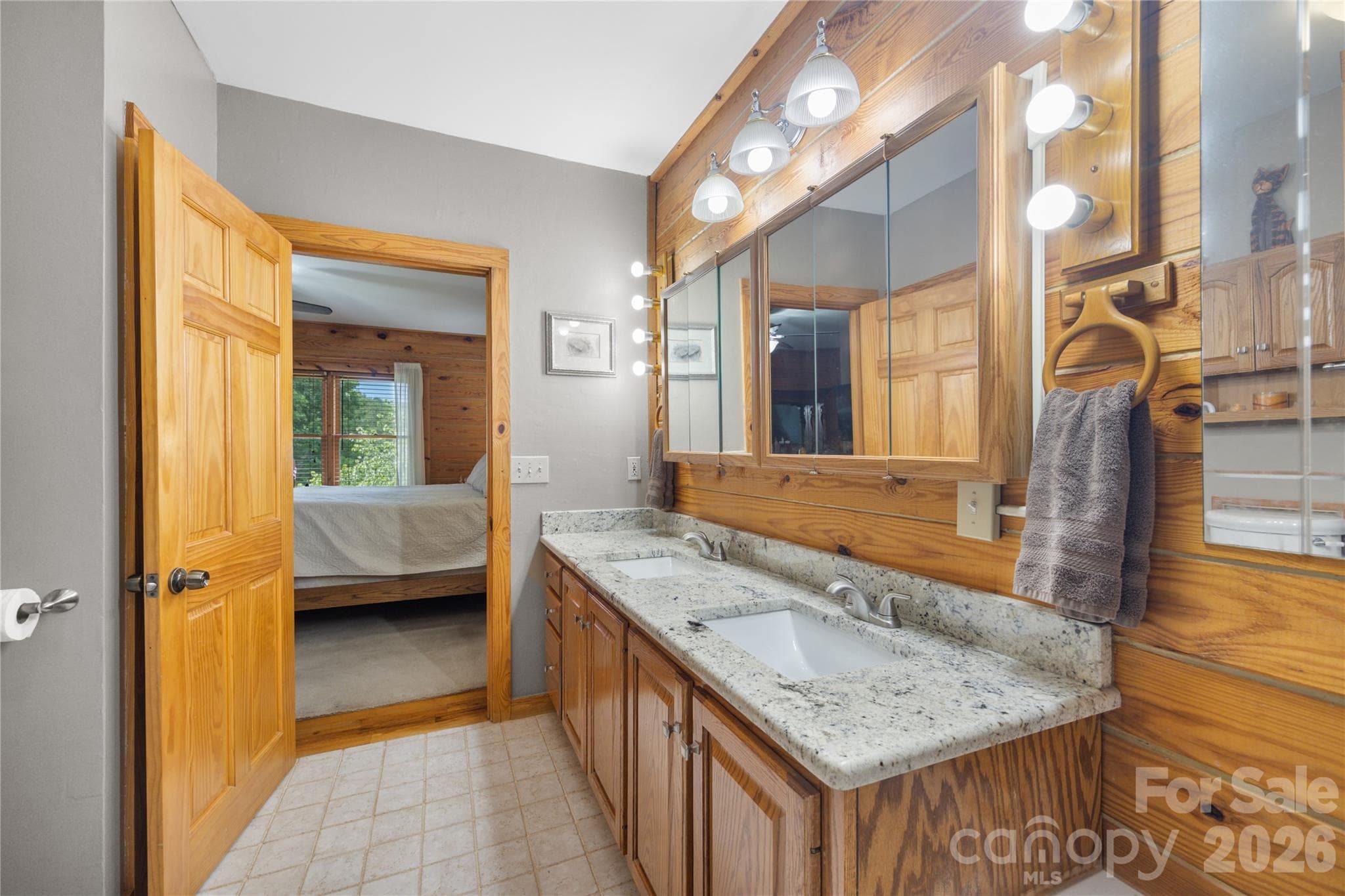 En suite primary bath with granite dual vanity - 214 Harbor Ridge Drive, Connelly Springs