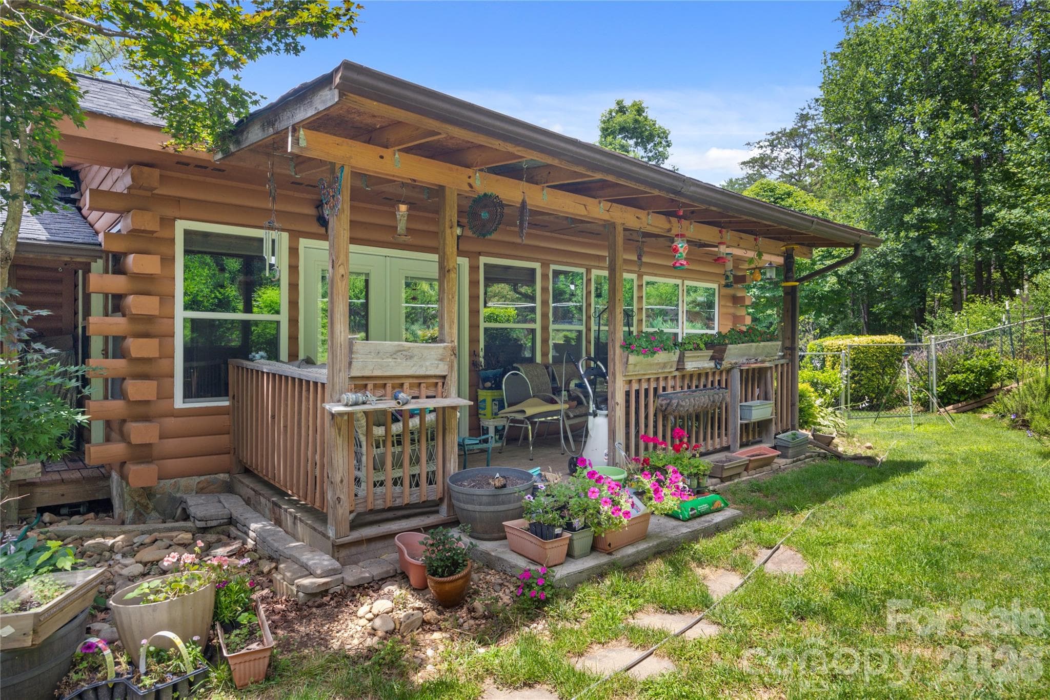 Covered porch is perfect for enjoying the beautiful fenced backyard. - 214 Harbor Ridge Drive, Connelly Springs