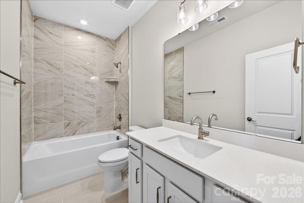 Secondary bathroom with tiled walls above the tub - 12015 Elsa Lane, Charlotte