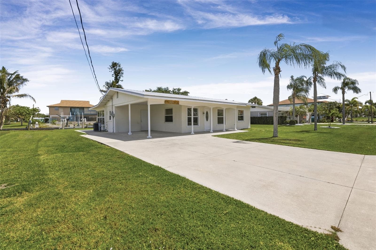Front of home and extra large concrete driveway - perfect for boat trailer storage - 10451 MARION ST, ENGLEWOOD