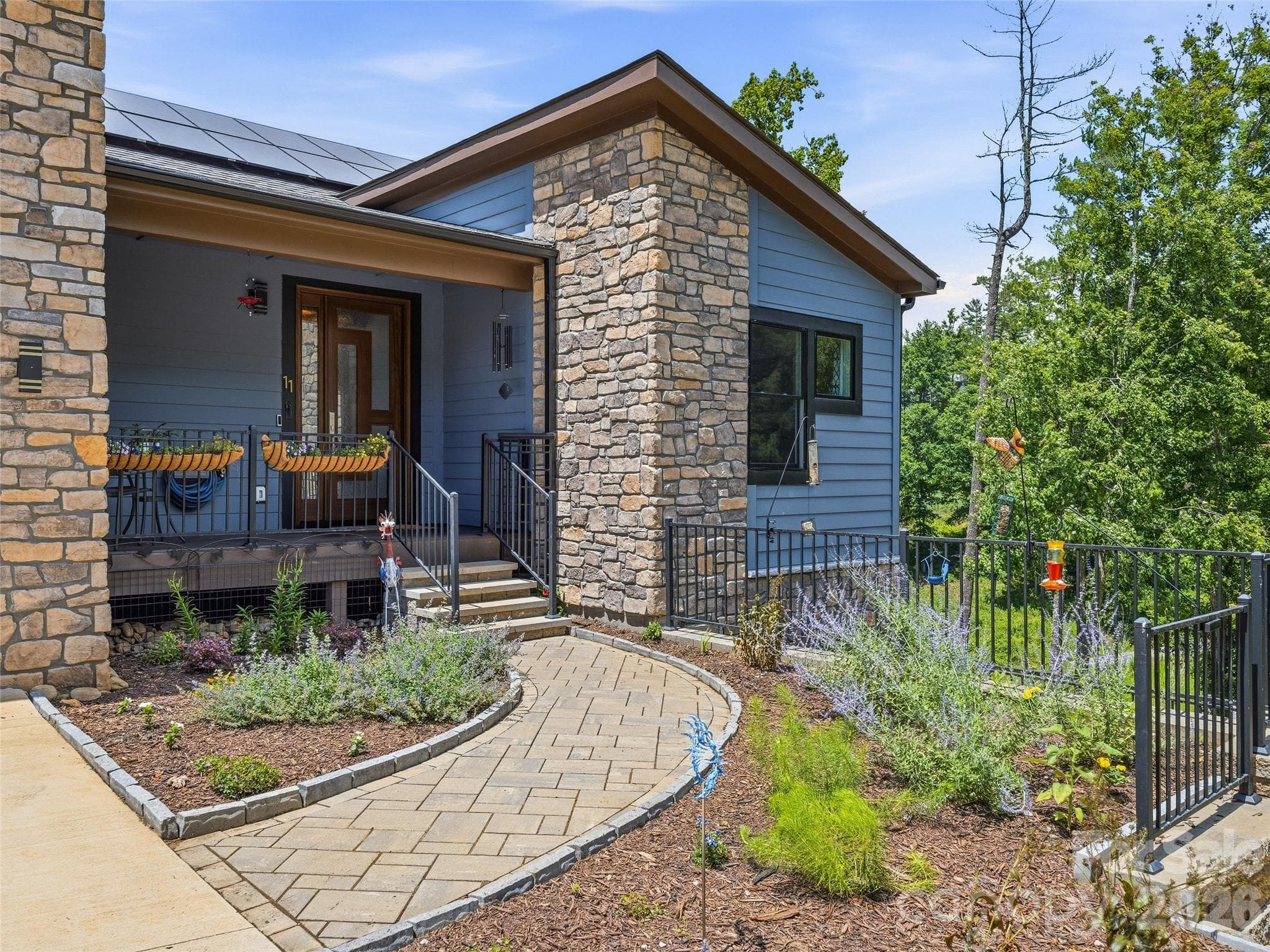 Relax on the front porch and enjoy the pollinator garden. - 11 Timber Hill Drive, Leicester
