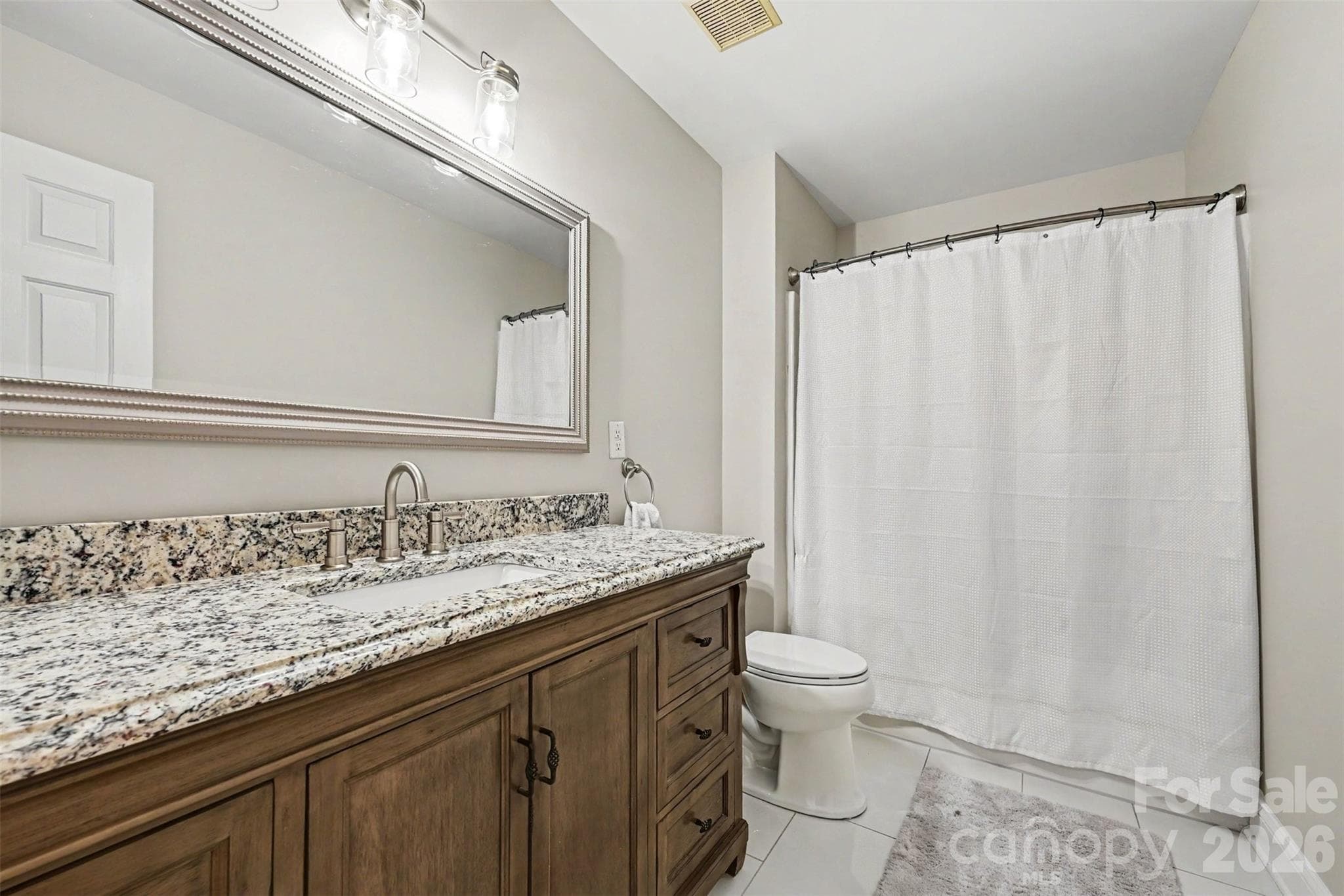 Upper full bath with new tile flooring. - 2442 Smith Cove Road, Denver