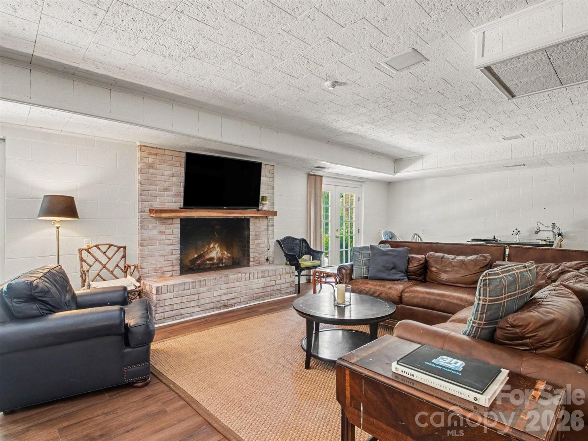 Gather around the fireplace in the lower level living room - 441 Claymont Street SE, Concord