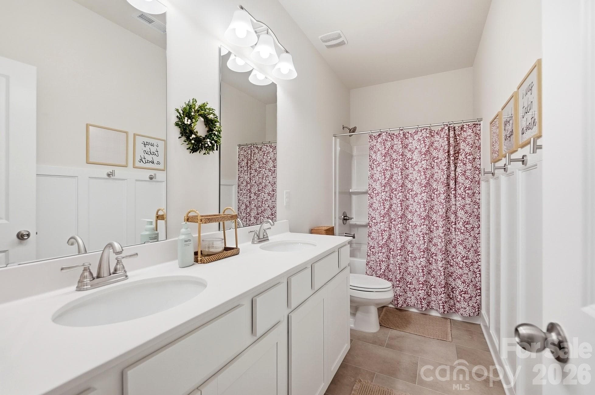 Full hall bath with double vanity serves the secondary bedrooms. - 6023 Busch Way, Midland