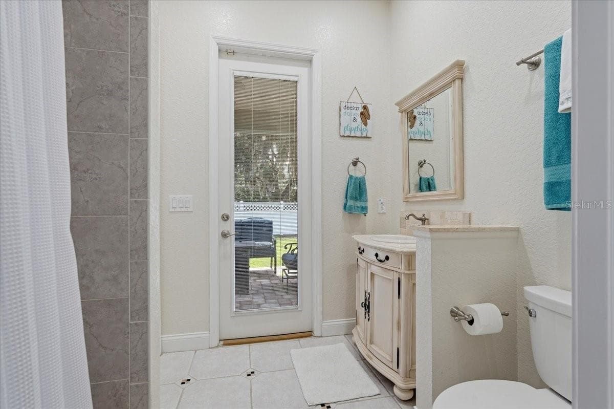 En suite bath leads to patio - 7014 JONES RD, ODESSA