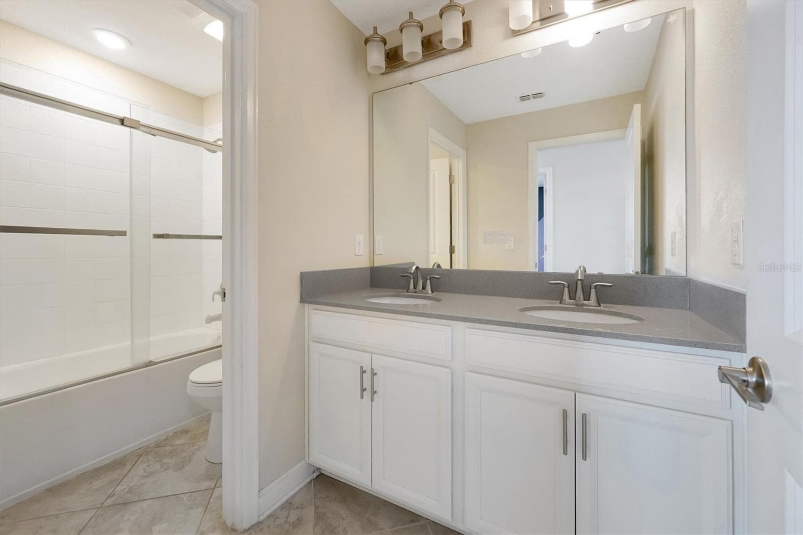 Full Bathroom 3 upstairs with dual-sink on elevated vanities - 12151 IMAGINARY WAY, ORLANDO