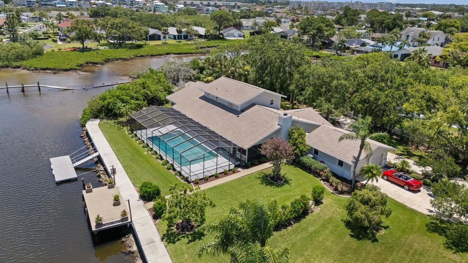 Aerial view of luxury home, pool, and docks with detached two car garage - 5623 HULL CT, NEW PORT RICHEY