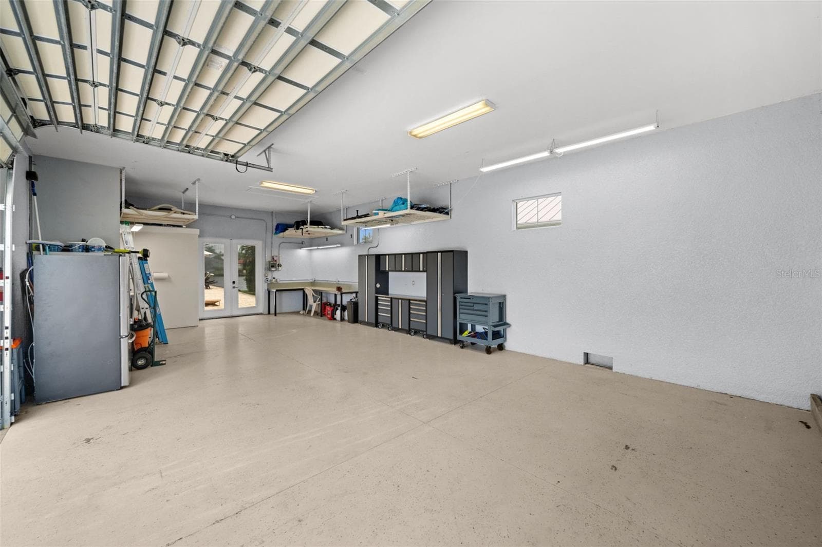 Soaring ceilings in the mancave give plenty of space to add lifts - 105 SW 52ND ST, CAPE CORAL